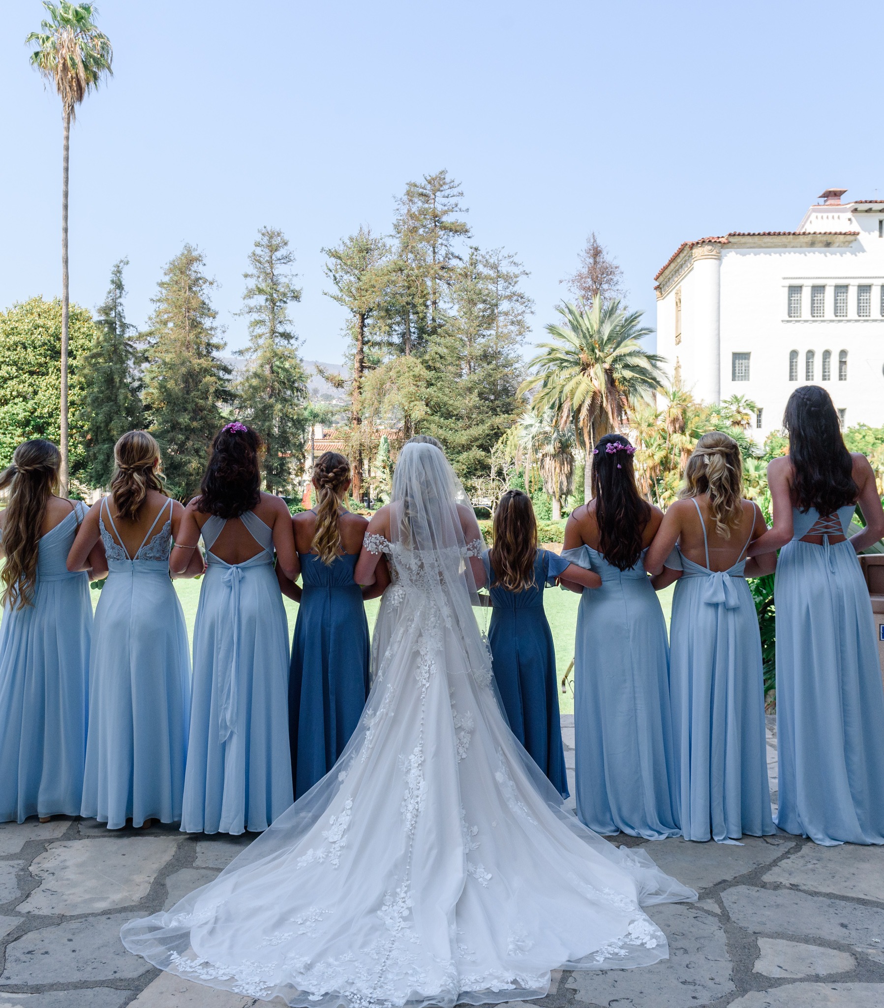 Bride and bridesmaids overlooking a garden venue
